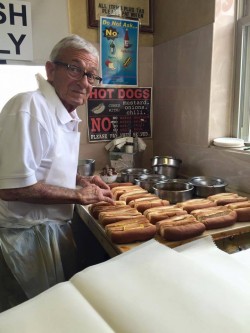 man preparing hot dogs