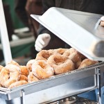 fried donuts covered in sugar in a pan