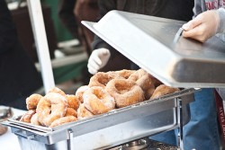 fried donuts covered in sugar in a pan