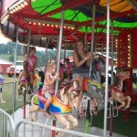 kids riding on a carousel
