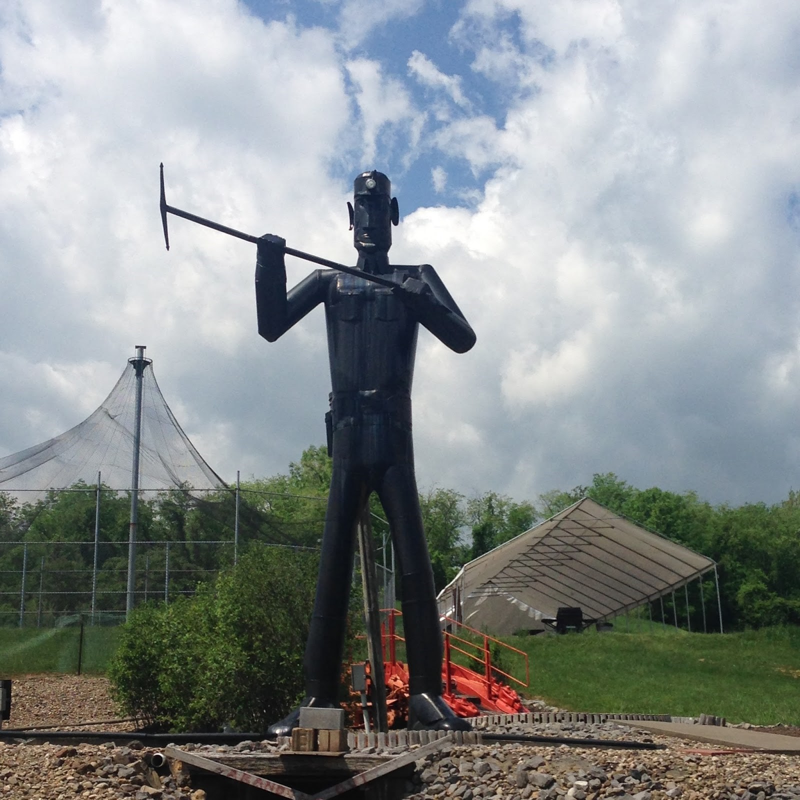 large metal statue of a coal miner holding a pick