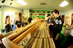 people looking through tubs of albums in a record store