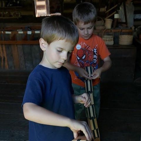 2 small boys playing a colonial game