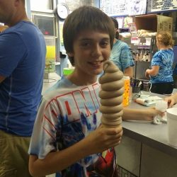 boy holding a large chocolate ice cream cone