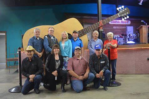 people in front of large guitar