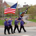 men carrying flags in parade