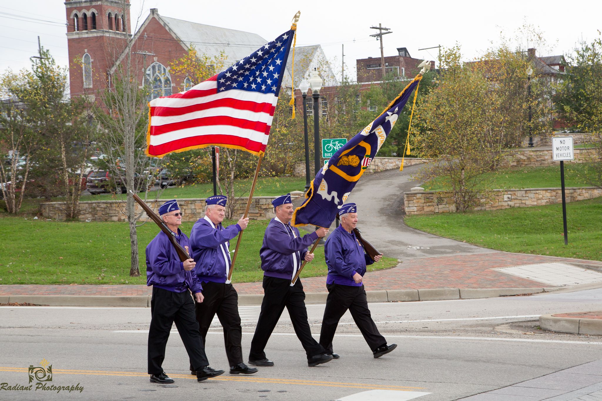 men carrying flags in parade