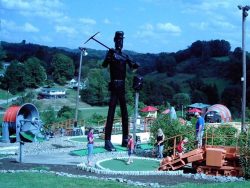 mini golf course with a large metal coal miner statue