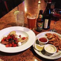 bruschetta, fried calamari, beer and cocktail at bar