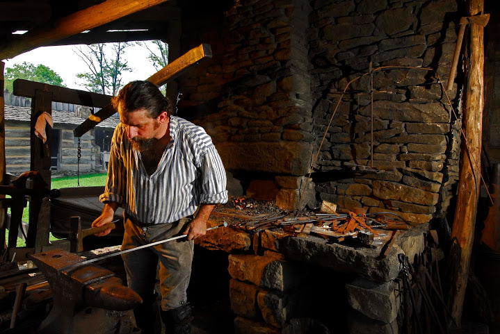 man dressed in frontier clothes portraying a blacksmith