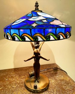 blue Tiffany lamp with a fairy at the base