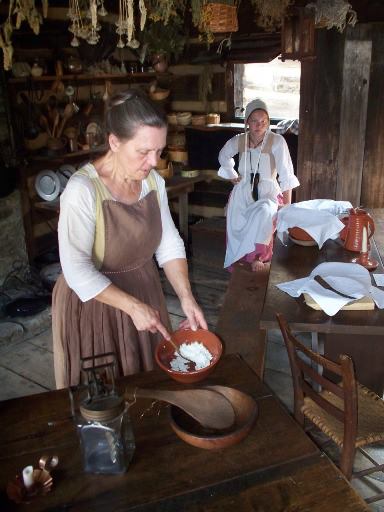 costumed interpreter demonstrating cooking