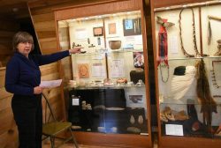 woman in front of a Native American display case