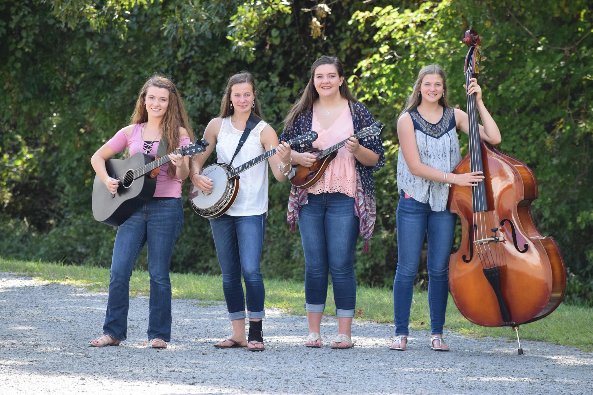 4 female bluegrass band holding string instruments
