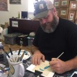 man painting with watercolors