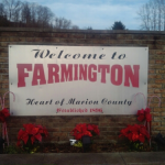 large white welcome sign with red letters for the Town of Farmington