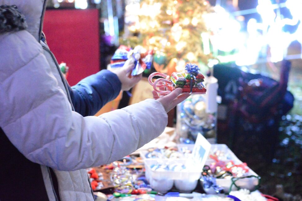 people shopping at an outdoor artisan market at Christmas time.