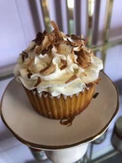cupcake with white icing and toasted coconut 