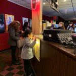 boy looking at the candy counter in a movie theater