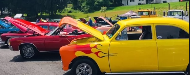 yellow classic car with red fire decal