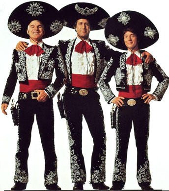 three men dressed in black Mexican-style hats, jackets and pants