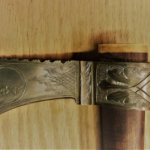 a metal axe with engravings