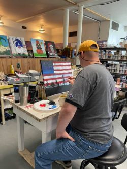 man painting an American flag