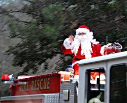 Santa riding on a fire truck