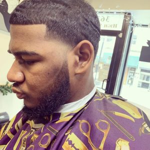 African American man getting a hair cut at a barbershop