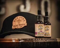 black ball cap with the logo Doc Jon's Private Reserve and two bottles of tincture