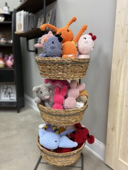 three tiered basket with crocheted stuffed animals