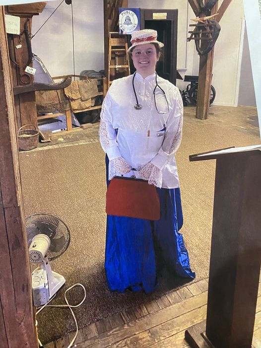 Photo of woman dressed as doctor from a past era.