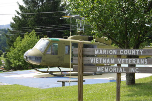 Photo of Huey Helicopter and sign.